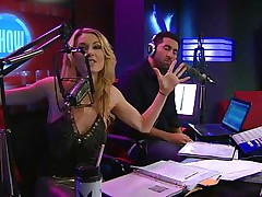 Playboy Radio's Morning Show has some of the hottest women you've ever seen! They're talking about Halloween costumes, and their guest has a cop outfit on that looks sexy as hell. It acquires even sexier when her top comes off, baring her tits. The female host comes over and helps shorten the skirt.